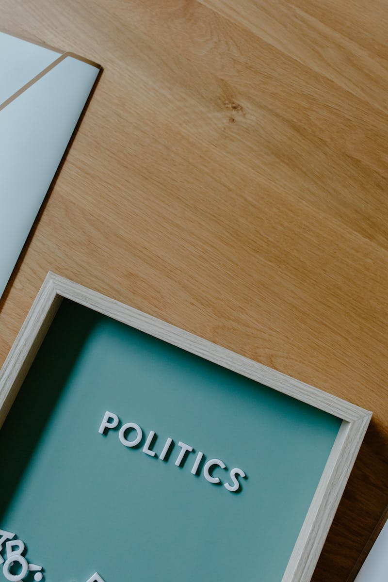 A top view of a modern setup conveying political themes with a sign and tray on a wooden table.